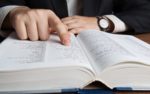 Man Looking In a Large Dictionary