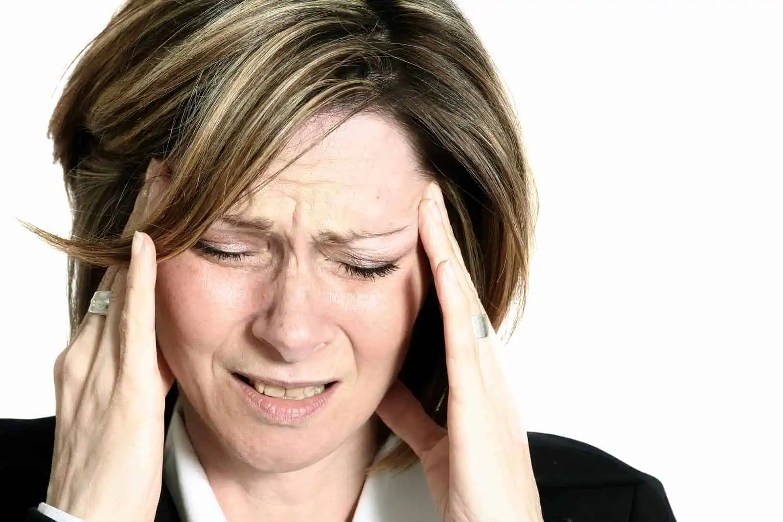 Businesswoman with headache holding her head and grimacing in pain